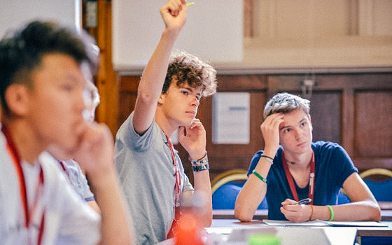 male student raising his hand in class