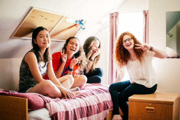 happy female students in boarding room