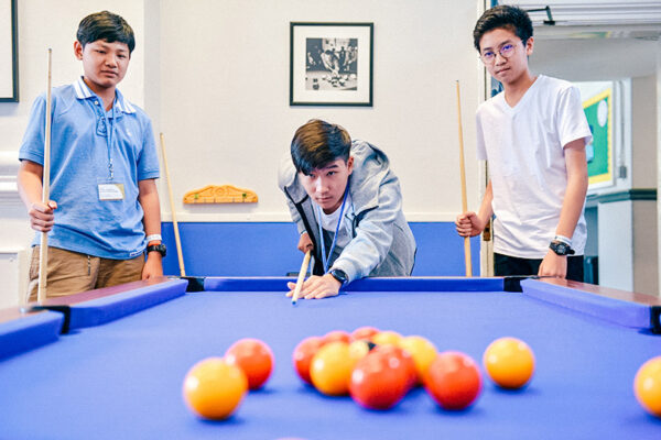 Eton College students playing a game of snooker together