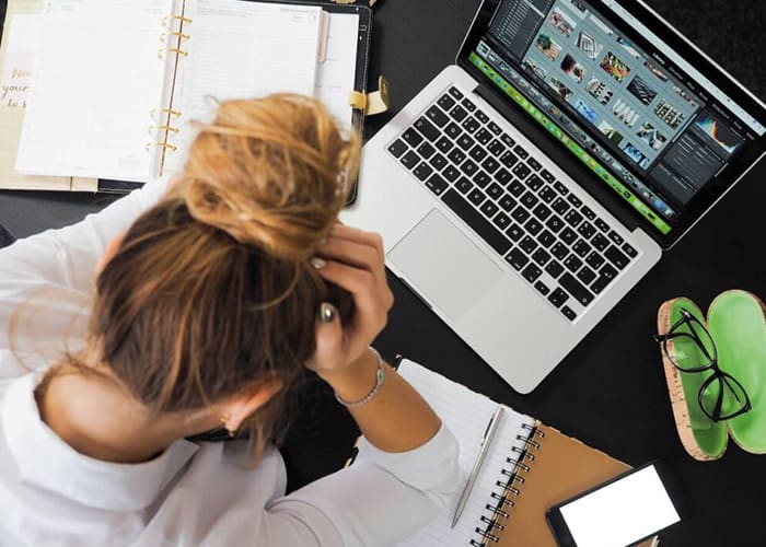 Female-student-stressed-on-laptop